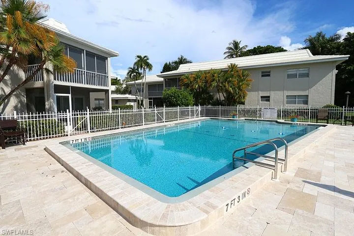 Community pool featuring a patio area and a sunroom