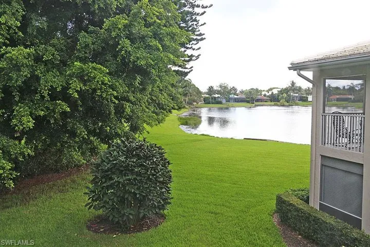View of grassy yard with a water view