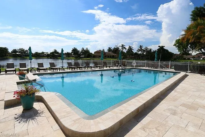 Community pool with a patio