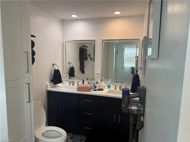 Bathroom featuring double vanity and toilet