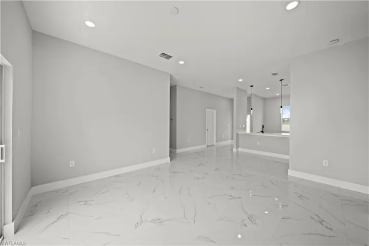 Spare room with recessed lighting and light marble finish floors