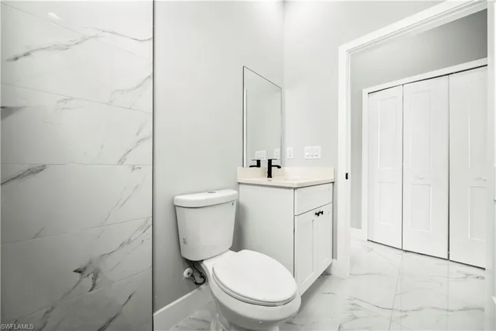 Bathroom with marble finish floors and vanity