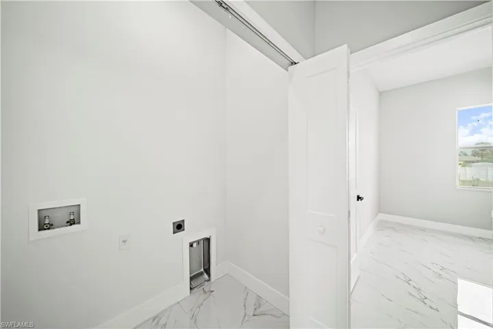 Laundry area featuring light marble finish floors, electric dryer hookup, and hookup for a washing machine
