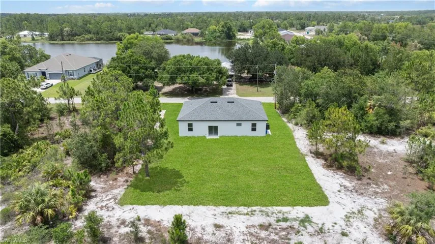Aerial view of property and surrounding area with a large body of water