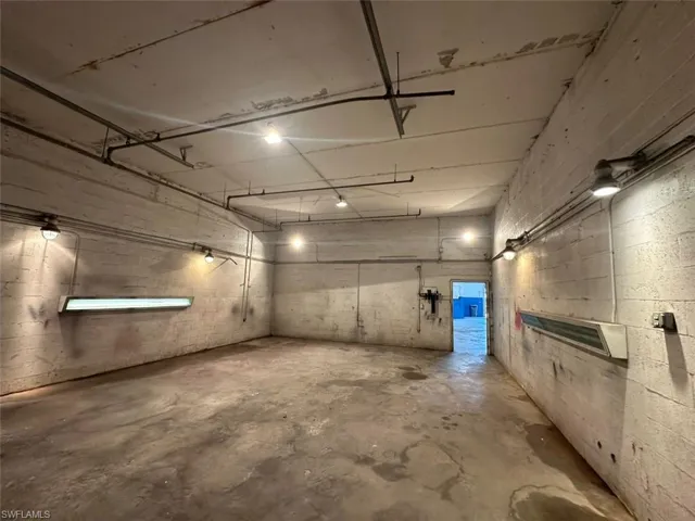 Garage featuring concrete block wall