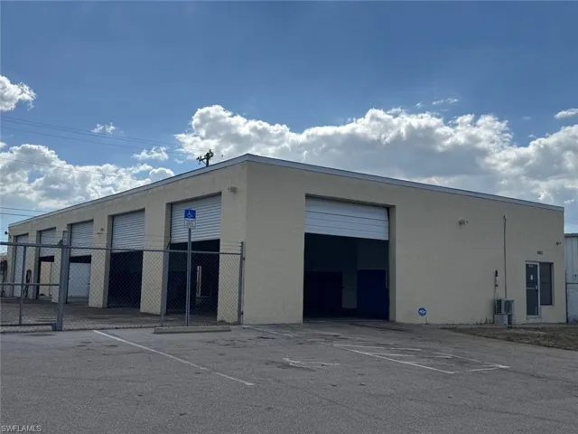 View of building exterior with uncovered parking