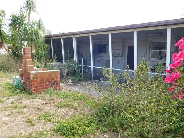 View of side of property featuring a sunroom