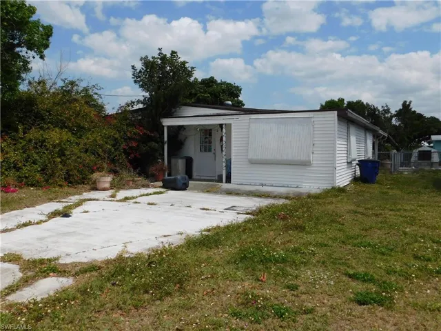 Back of house with a lawn