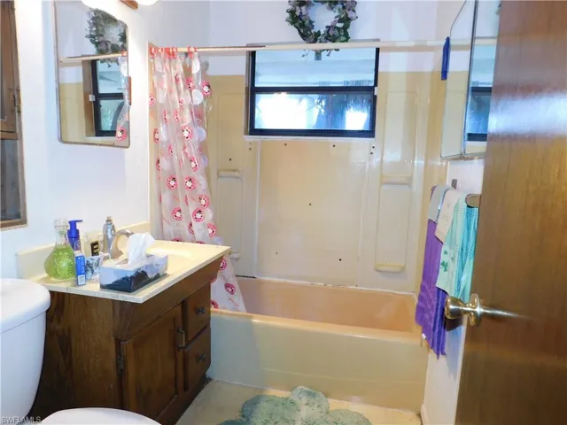 Full bath featuring shower / tub combo, toilet, and vanity