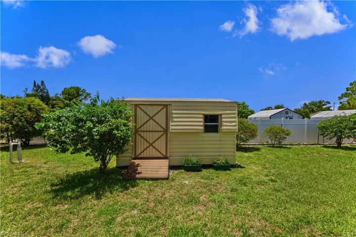 View of shed / structure with a lawn