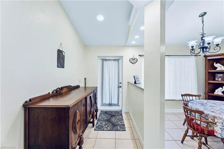 Tiled foyer entrance featuring a chandelier