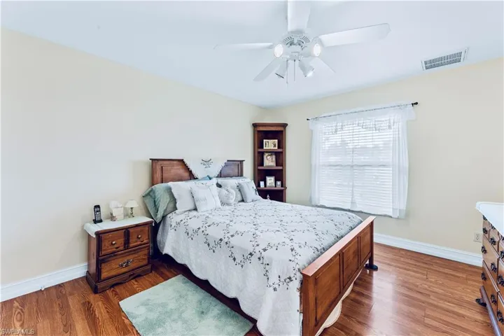 Bedroom featuring dark wood-type flooring and ceiling fan