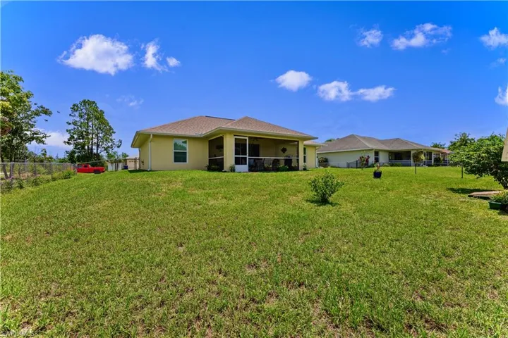 Back of property featuring a yard