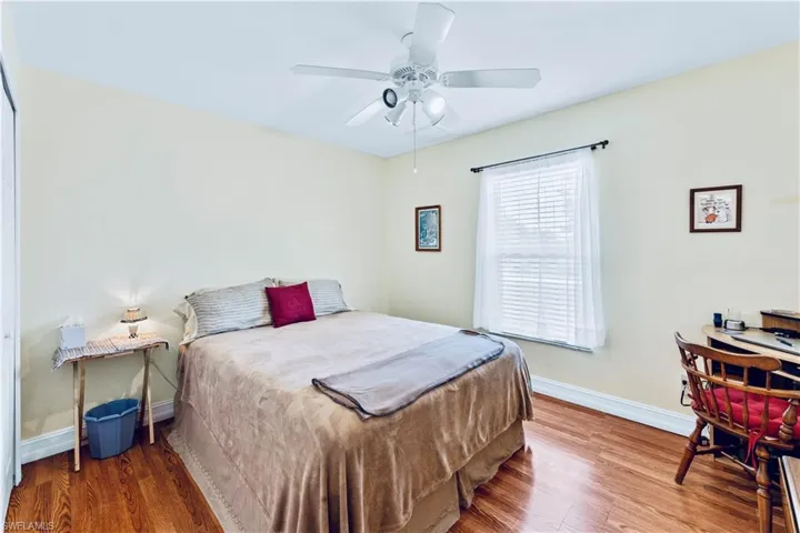 Bedroom featuring ceiling fan and hardwood / wood-style floors