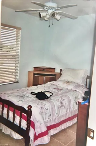 Bedroom featuring tile flooring and ceiling fan