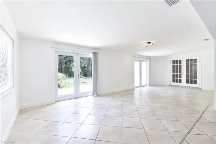 Spacious room featuring light-toned tile flooring throughout
