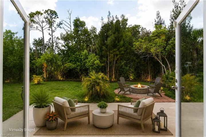 Expansive backyard featuring a lush lawn and mature trees
