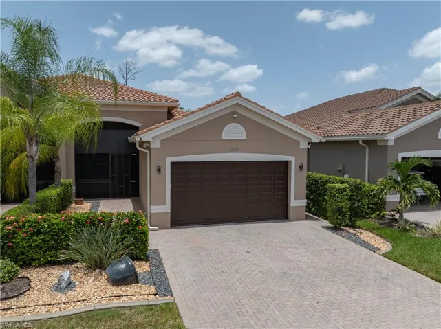 Mediterranean-style residence featuring a tile roof and stucco exterior