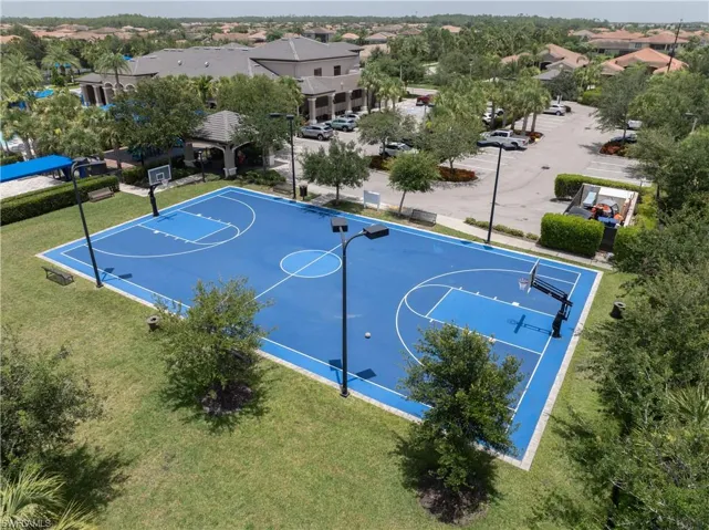 Outdoor basketball court with a blue playing surface and white line markings