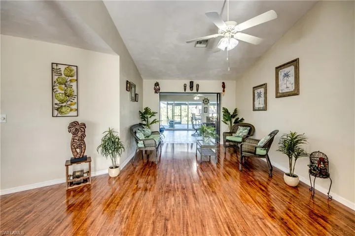 Additional view of the living room highlighting open layout and ceiling fan.