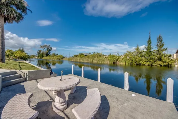Dock and seating area with wide canal views—relax and enjoy the waterfront lifestyle.
