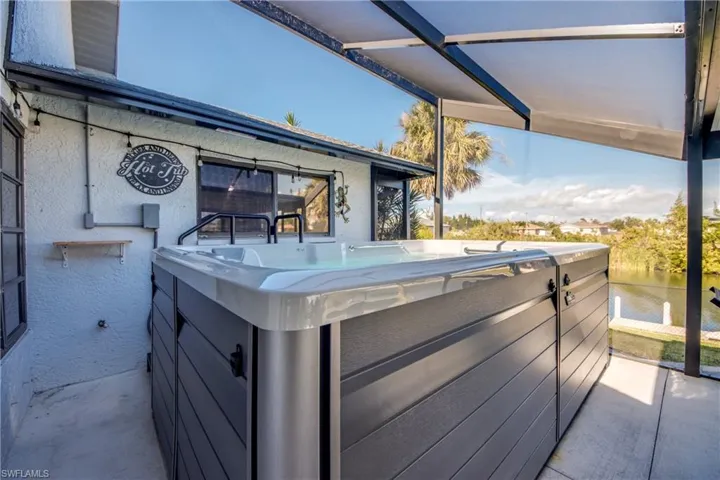 Covered swim spa on the screened lanai—relax and enjoy waterfront living in Cape Coral.