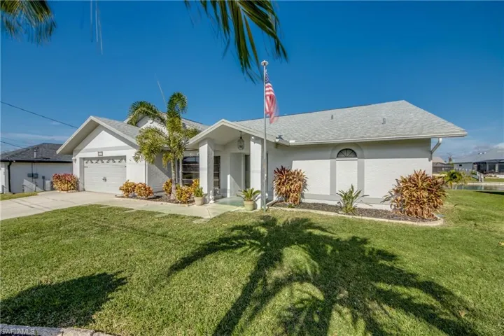 Alternate front view showing curb appeal, tropical palm trees, and clean architectural lines.