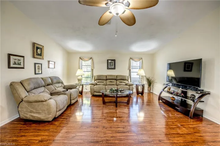 Living area with wood finished floors and ceiling fan