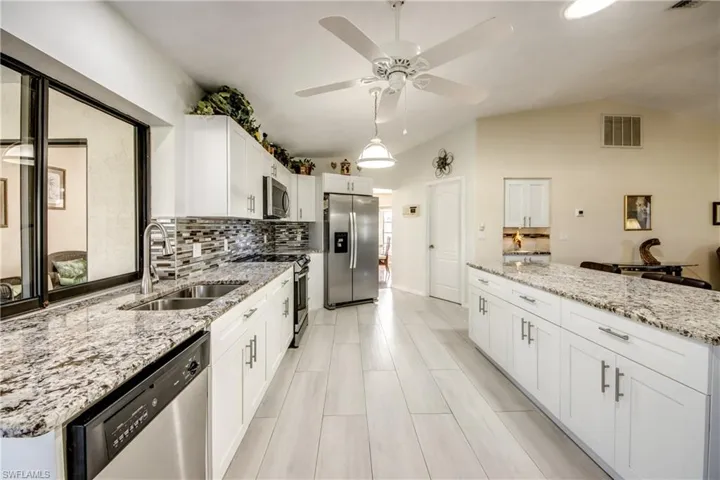 Kitchen featuring light cabinetry, tile flooring, and generous prep areas.