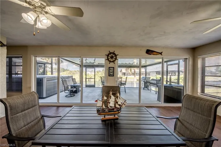Sunroom showcasing wide waterfront views of the Cape Coral freshwater canal.