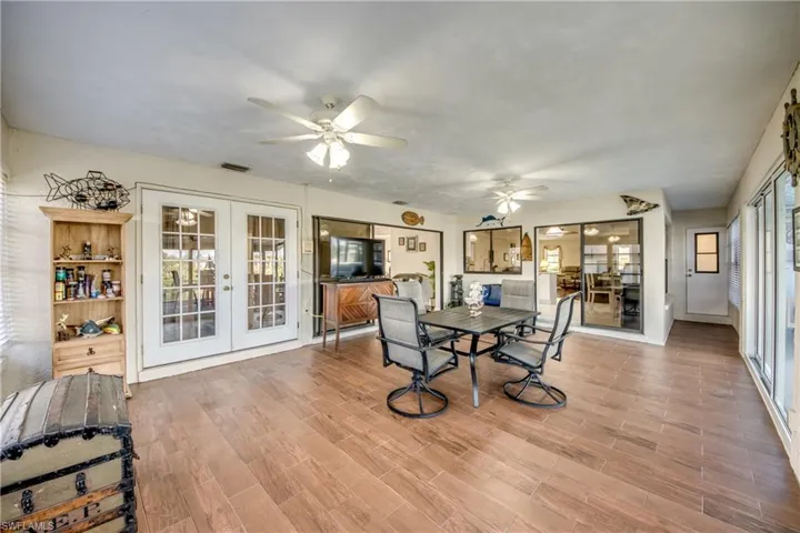 Bright sunroom / Florida room with seating space and views—enjoy the waterfront lifestyle in Cape Coral.