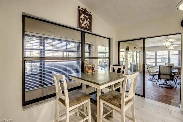 Casual dining space adjacent to the kitchen with window views and natural light.