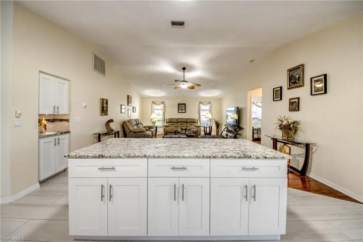 Kitchen with central island, pendant lighting, and functional workspace.