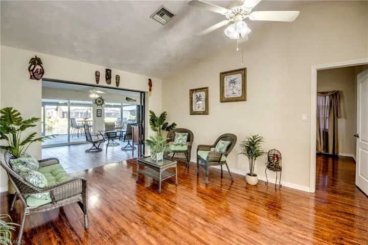Living room with large windows, natural light, and views toward the dining area.