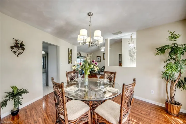 Dining room featuring wood finished floors and a chandelier