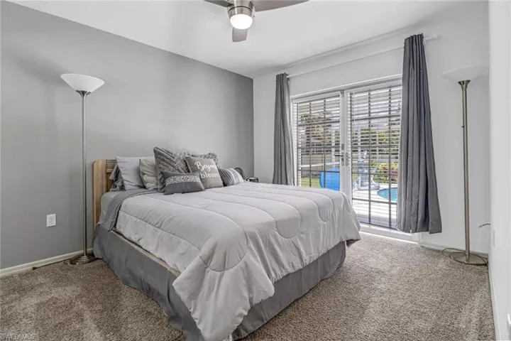 Bedroom with carpet, ceiling fan, and access to exterior