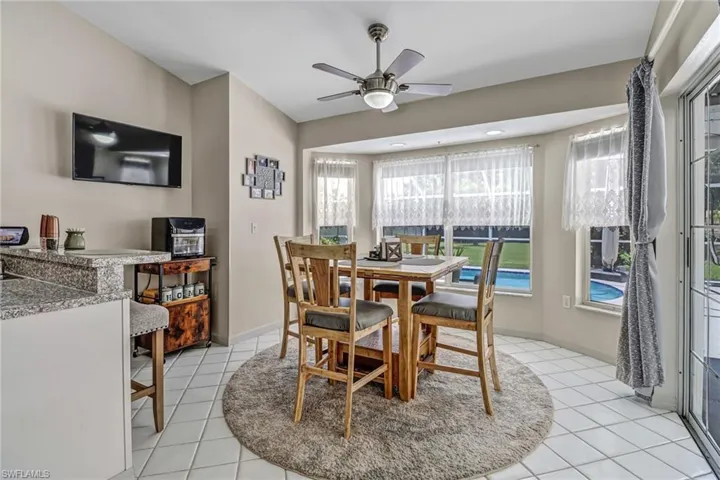 Dining space featuring light tile patterned flooring and ceiling fan