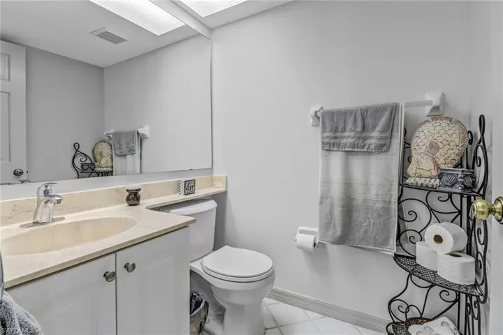 Bathroom featuring toilet, vanity, and tile patterned flooring