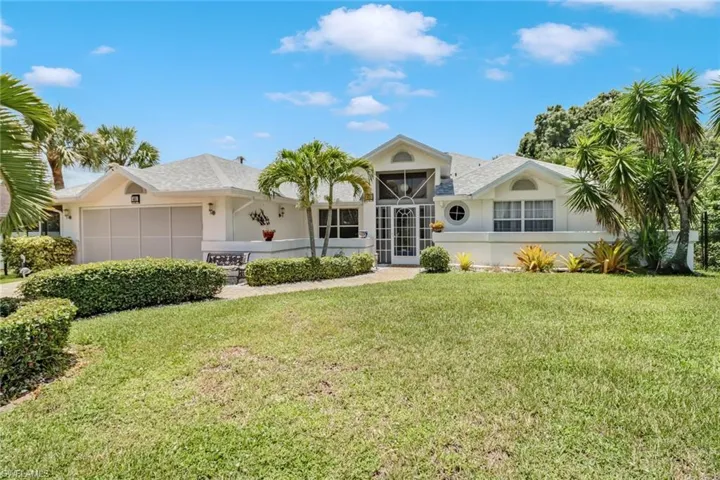 Ranch-style home featuring a front lawn and a garage