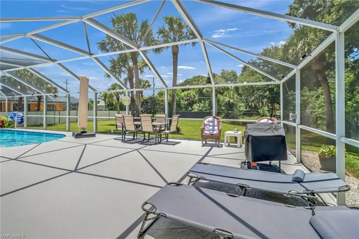 View of patio featuring a lanai