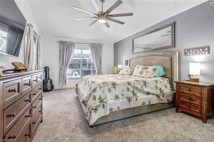 Bedroom with light colored carpet and ceiling fan