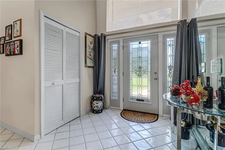 Entrance foyer featuring light tile patterned flooring and a healthy amount of sunlight