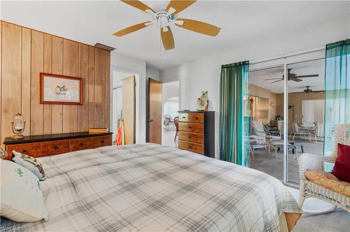 Carpeted bedroom featuring access to exterior and ceiling fan