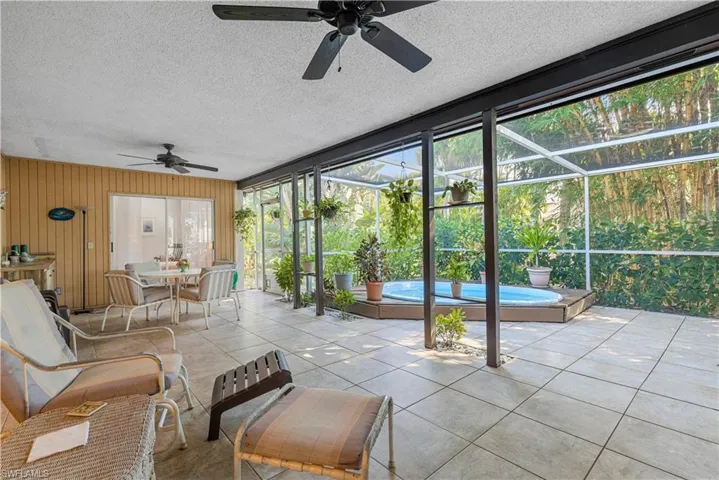 Sunroom featuring ceiling fan