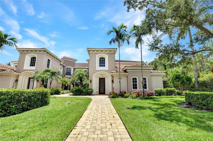 Mediterranean / spanish-style home featuring a front lawn, stucco siding, and a tile roof