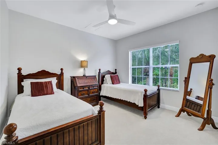 Bedroom with light colored carpet and ceiling fan