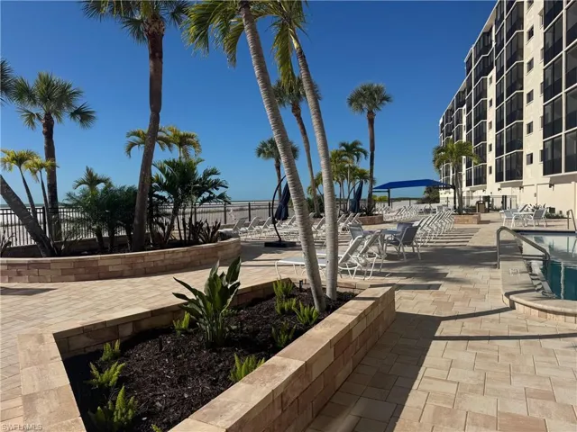 View of community featuring a patio area, a swimming pool, and a water view