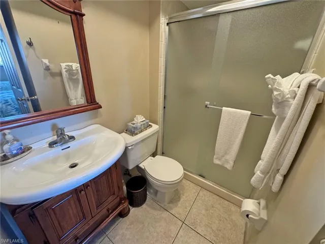 Full Guest bathroom featuring vanity, a shower stall, and light tile patterned floors