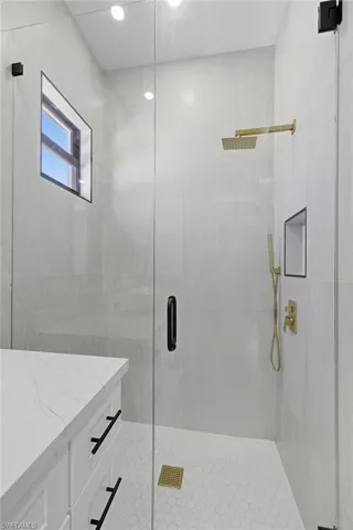 Bathroom with a shower stall and vanity