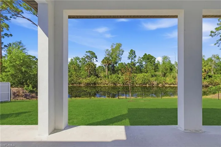 Doorway to outside featuring a water view and view of scattered trees